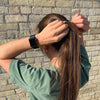 Brunette pulling high pony tight with earth tints plastic-free mondo hair ties