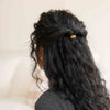 curly black hair in half-up-half-down style with golden fibres mini hair tie