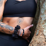 KOOSHOO plastic-free jet black hair ties off-packaging and stacked #color_black