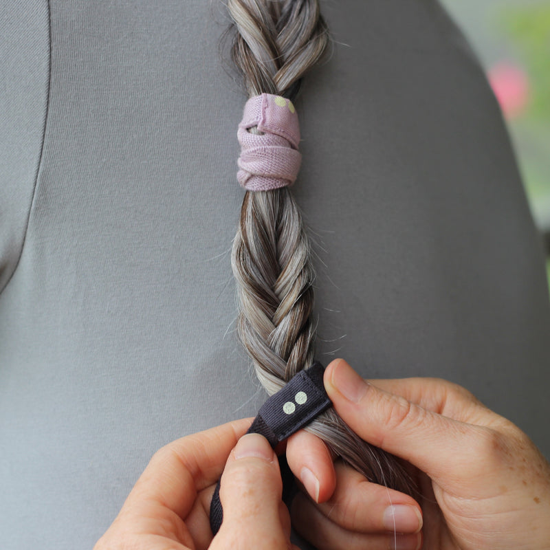KOOSHOO plastic-free hair ties in plaited silver hair. Lilac and navy blue hair ties #color_silver