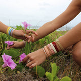 KOOSHOO ginger plastic-free hair ties on seagrass and pink flowers #color_ginger