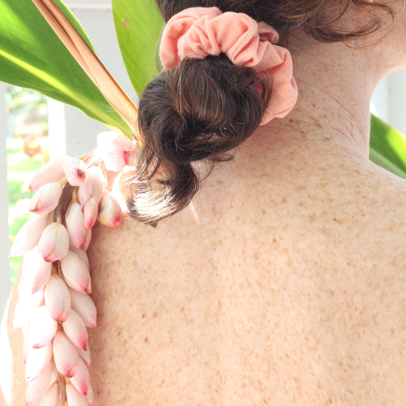 KOOSHOO plastic free scrunchies coral rose with garlic flower hanging over back #color_coral-rose