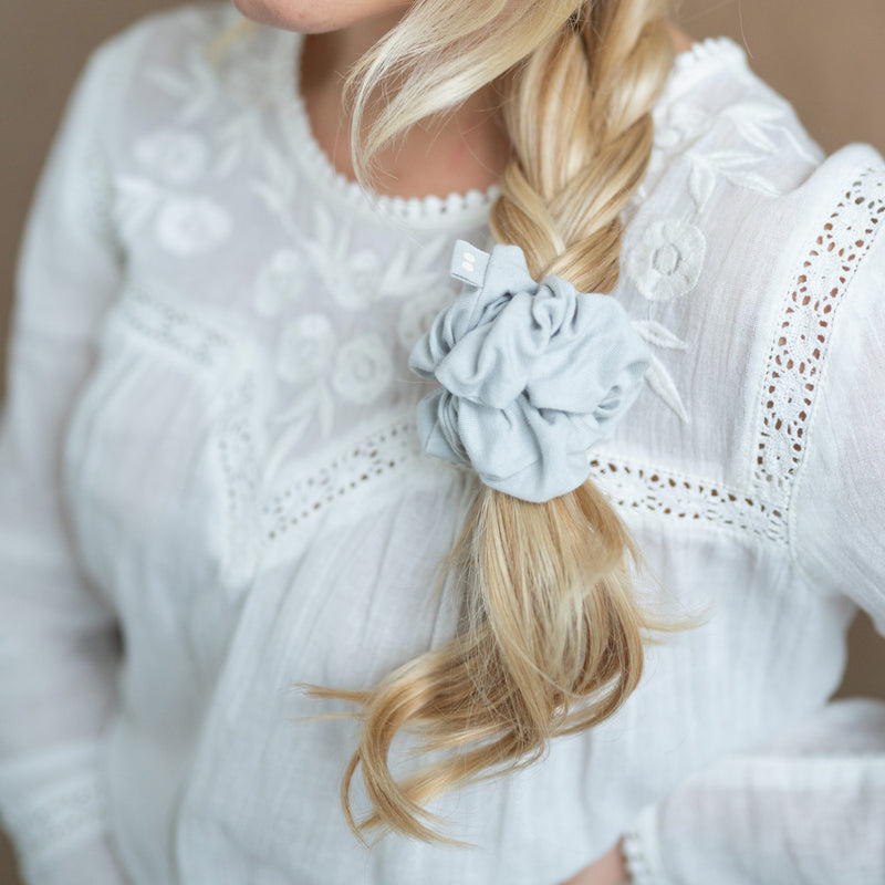KOOSHOO organic cotton scrunchie evening sky, light blue on side plait with white blouse #color_moon-shadow